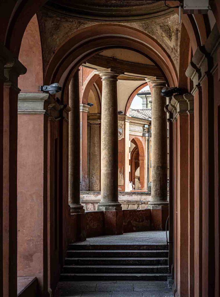 Curved section of the Portico di San Luca with arches and columns.