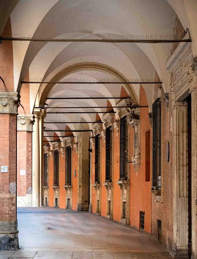 Long perspective beneath arcades on Via Castiglione.