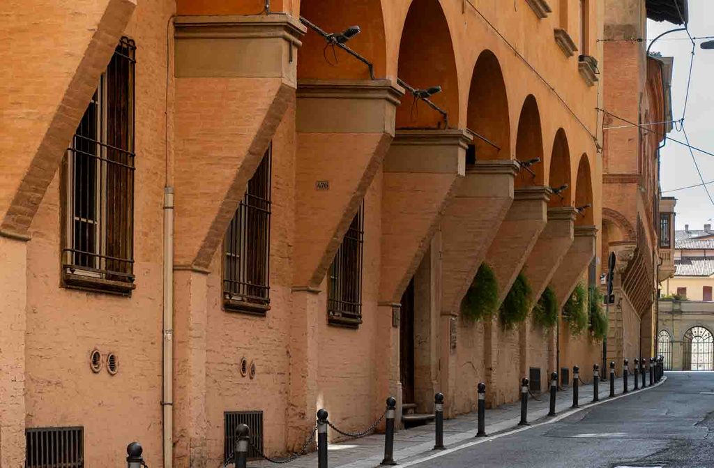 Brick arcades along a quiet street near Piazza San Domenico.